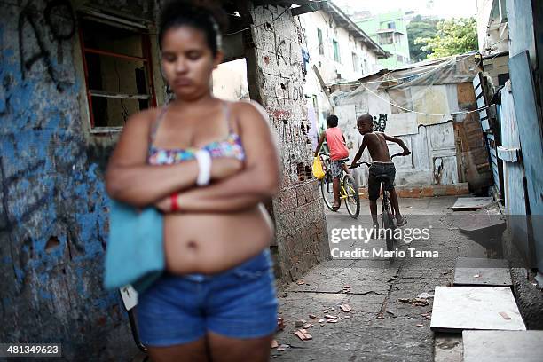 People gather in an impoverished section of the unpacified Complexo da Mare slum complex, one of the largest 'favela' complexes in Rio, on March 29,...