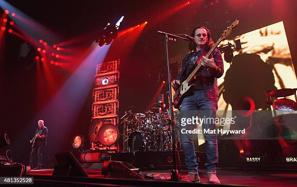Alex Lifeson, Neil Peart and Geddy Lee of Rush perform on stage during the R40 LIVE Tour at KeyArena on July 19, 2015 in Seattle, Washington.