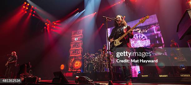 Alex Lifeson, Neil Peart and Geddy Lee of Rush perform on stage during the R40 LIVE Tour at KeyArena on July 19, 2015 in Seattle, Washington.