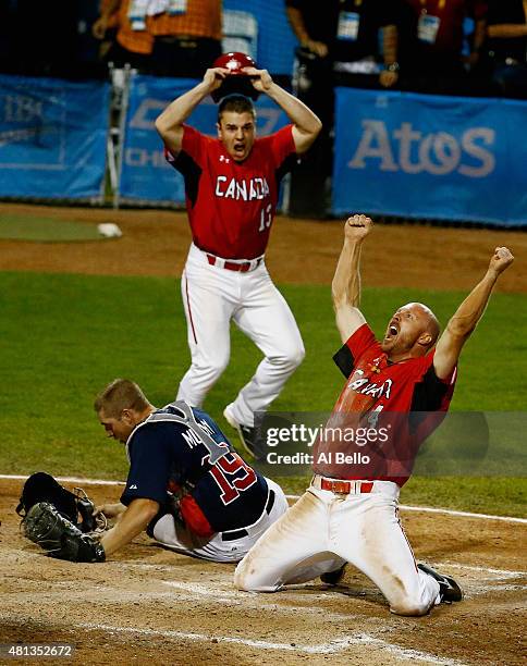 Peter Orr of Canada celebrates scoring the winning run in the tenth inning as Thomas Murphy of the USA and Tyler O'Neill of Canada looks after their...