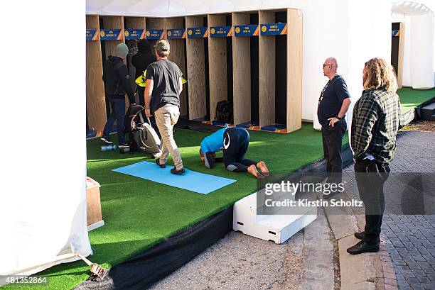 Mick Fanning of Australia collapses on the floor of the surfers locker room after returning safely to shore after being attacked by a shark during...