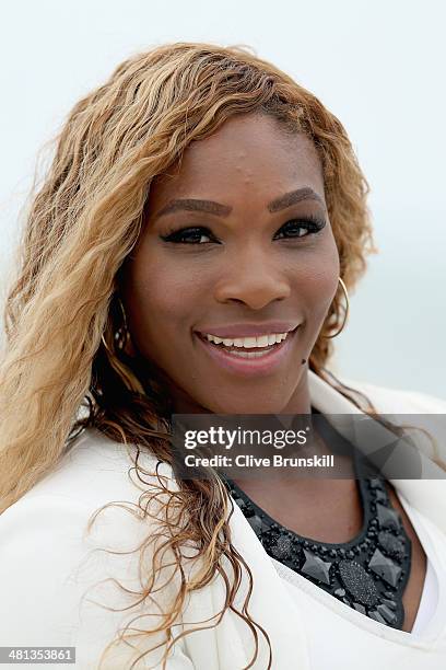 Serena Williams of the United States poses for photographs on Crandon Park beach after her straight sets victory against Li Na of China during their...