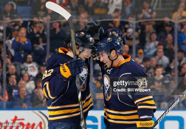 Matt D'Agostini of the Buffalo Sabres celebrates his first period goal against the Tampa Bay Lightning with teammate Marcus Foligno on March 29, 2014...