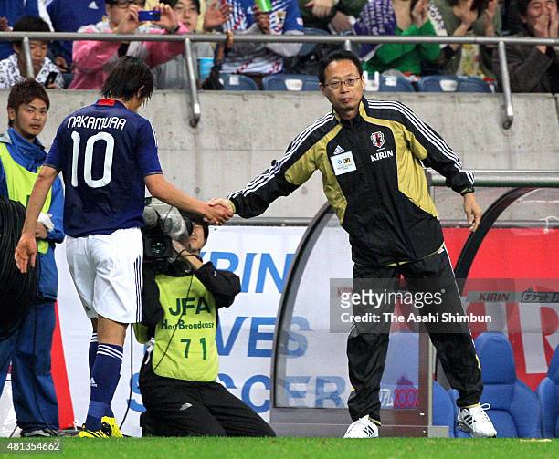 Head coach Takeshi Okada shakes hands with Shunsuke Nakamura during the international friendly match between Japan and South Korea at Saitama Stadium...