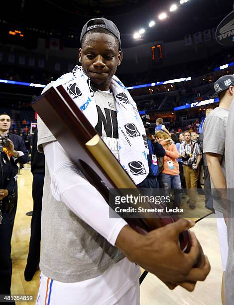 Will Yeguete of the Florida Gators celebrates with the trophy on the court after defeating the Dayton Flyers 62-52 in the south regional final of the...