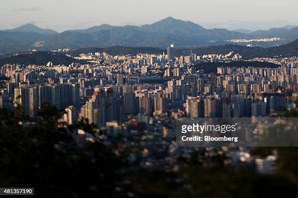 Buildings stand in this photograph taken with a tilt-shift lens in Seoul, South Korea, on Thursday, July 16, 2015. A report on July 23 may show that...