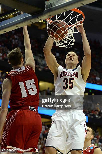 Kaleb Tarczewski of the Arizona Wildcats dunks the ball over Sam Dekker of the Wisconsin Badgers in the first half during the West Regional Final of...