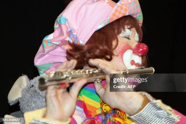 By Mark Guarino Clown Yurie Hioki of Osaka, Japan gives a flute performance of "Somewhere Over the Rainbow" during the World Clowning Association...