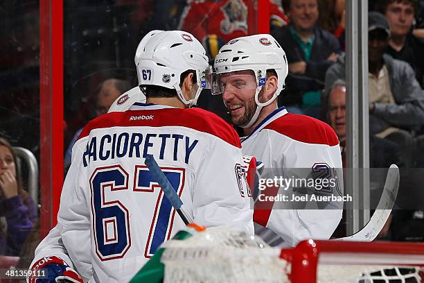 Max Pacioretty is congratulated by Thomas Vanek of the Montreal Canadiens after he scored a second period goal against the Florida Panthers at the...