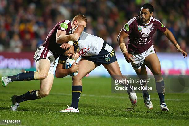 Tom Symonds of the Eagles tackle Jason Taumalolo of the Cowboys during the round 19 NRL match between the Manly Sea Eagles and the North Queensland...