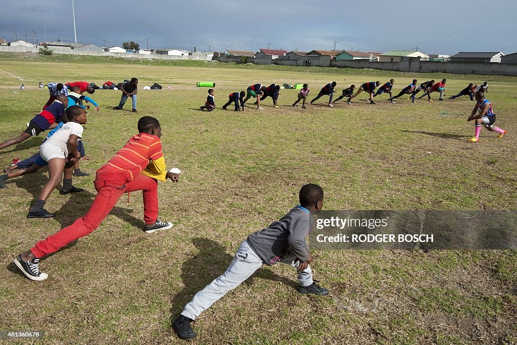 Underprivilaged Rugby Program Young boys practice rugby on a field in Khayelitsha, an impoverished ...
