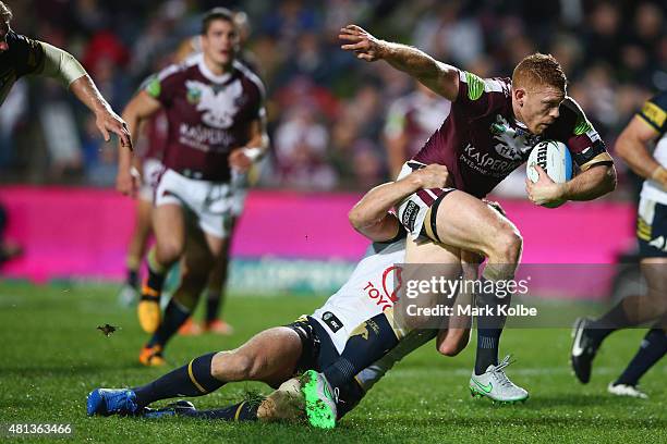 Tom Symonds of the Eagles is tackled during the round 19 NRL match between the Manly Sea Eagles and the North Queensland Cowboys at Brookvale Oval on...