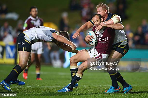 Brett Stewart of the Eagles is tackled during the round 19 NRL match between the Manly Sea Eagles and the North Queensland Cowboys at Brookvale Oval...