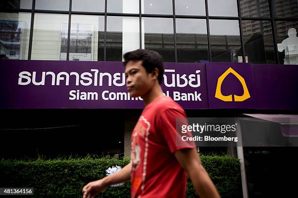 Pedestrian walks past a Siam Commercial Bank Pcl branch in the Sukhumvit area of Bangkok, Thailand, on Monday, July 20, 2015. Siam Commercial Bank is...