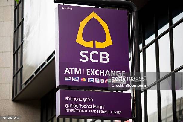 Siam Commercial Bank signage hangs outside a branch in the Sukhumvit area of Bangkok, Thailand, on Monday, July 20, 2015. Siam Commercial Bank is...