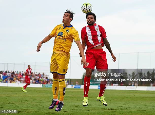 Benoit Tremoulinas of Sevilla battles for the ball with Sergio Guardiola of Alcorcon during a Pre Season Friendly match between Sevilla and Alcorcon...