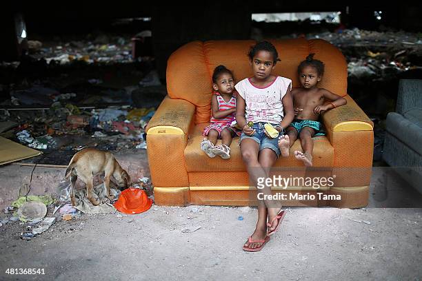 Children look at the camera in an impoverished area in the unpacified Complexo da Mare slum complex, one of the largest 'favela' complexes in Rio, on...