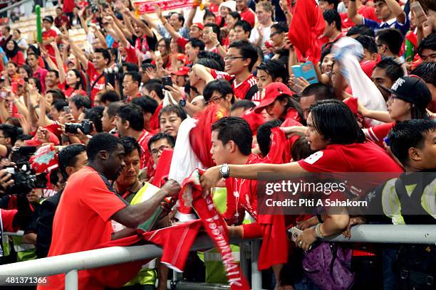 Kolo Toure of Liverpool gives his autograph to a football fan after a friendly match against the Thailand All-Stars team on 14 July 2015 in Bangkok...