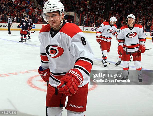 Andrei Loktionov of the Carolina Hurricanes skates to the bench to celebrate his third-period goal with teammates during their NHL game against the...