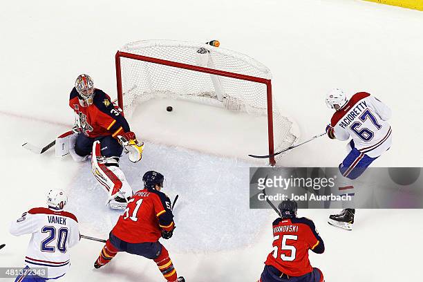 Max Pacioretty of the Montreal Canadiens scores his first goal of the night past goaltender Dan Ellis of the Florida Panthers during first period...