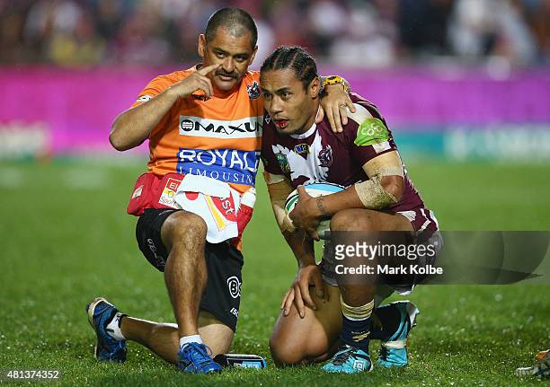 Steve Matai of the Eagles receives attention from the trainer during the round 19 NRL match between the Manly Sea Eagles and the North Queensland...