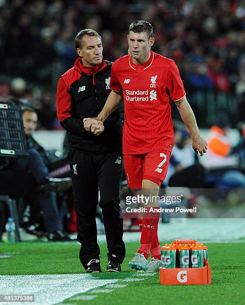 James Milner of Liverpool shakes hands with Brendan Rodgers manager of Liverpool after being taken off during the international friendly match...