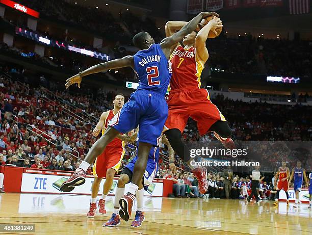 Darren Collison of the Los Angeles Clippers blocks a shot by Jeremy Lin of the Houston Rockets during the game at the Toyota Center on March 29, 2014...