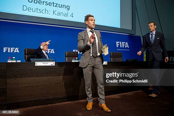 Comedian Simon Brodkin prepares to attack FIFA President Joseph S. Blatter with money during a press conference at the Extraordinary FIFA Executive...
