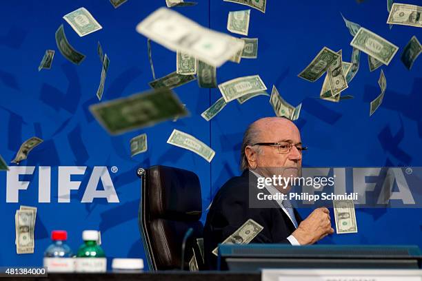 Comedian Simon Brodkin throws cash at FIFA President Joseph S. Blatter during a press conference at the Extraordinary FIFA Executive Committee...