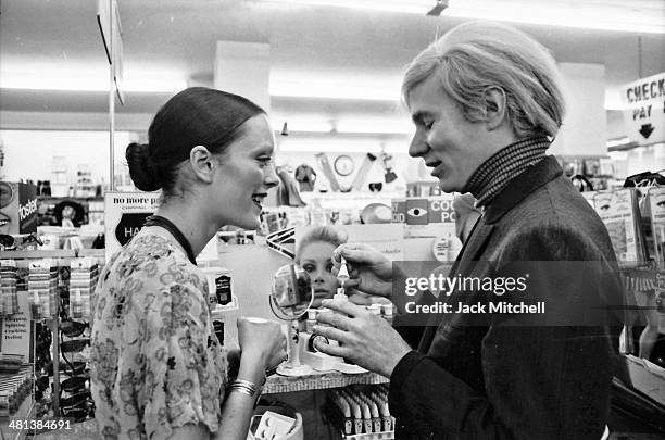 Jane Forth and Andy Warhol shopping for cosmetics, 1970.