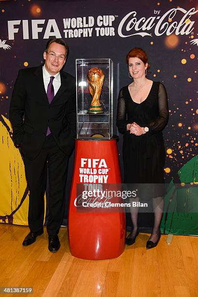 Monica Lierhaus and Rolf Hellgardt pose with the trophy during a photocall at the Gala Night of the FIFA World Cup Trophy Tour on March 29, 2014 in...