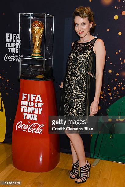 Sanny van Heteren poses with the trophy at the Gala Night of the FIFA World Cup Trophy Tour on March 29, 2014 in Berlin, Germany.
