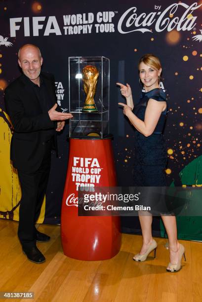 Tina Ruland and Claus G. Oldoerp pose with the trophy at the Gala Night of the FIFA World Cup Trophy Tour on March 29, 2014 in Berlin, Germany.