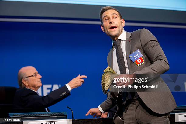 Comedian Simon Brodkin prepares to attack FIFA President Joseph S. Blatter with money during a press conference at the Extraordinary FIFA Executive...