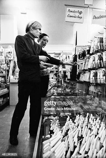 Jane Forth and Andy Warhol shopping for cosmetics, 1970.