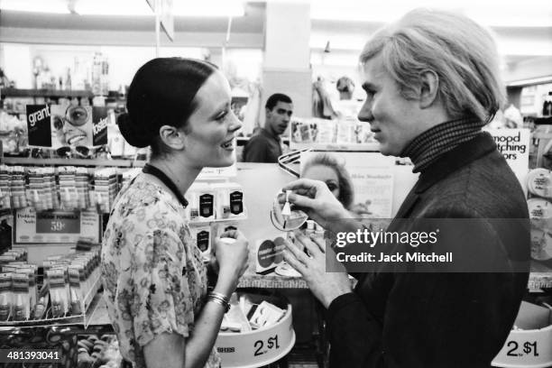 Jane Forth and Andy Warhol shopping for cosmetics, 1970.