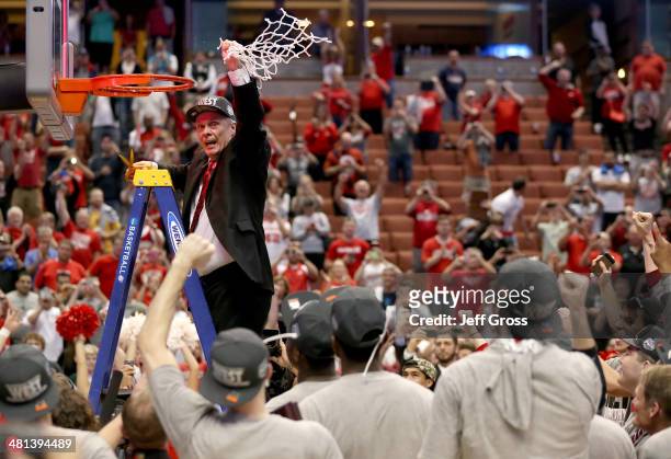 Head coach Bo Ryan of the Wisconsin Badgers celebrates after he cuts down the net after defeating the Arizona Wildcats 64-63 in overtime during the...