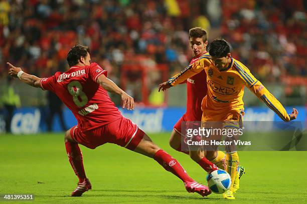 Aaron Galindo of Toluca struggles for the ball with Alan Pulido of Tigres during a match between Toluca and Tigres UANL as part of the 13th round of...