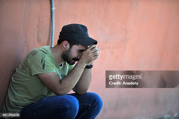 Some of people who arrive to the site of an explosion targeting a cultural center, cry in Suruc district of Sanliurfa, Turkey on July 20, 2015. At...