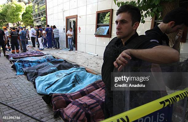 Bodies are seen at the site of an explosion targeting a cultural center in Suruc district of Sanliurfa, Turkey on July 20, 2015. At least 27 people...