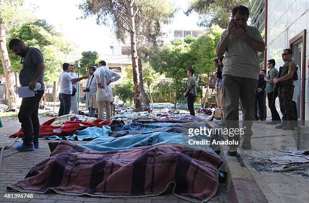 Bodies are seen at the site of an explosion targeting a cultural center in Suruc district of Sanliurfa, Turkey on July 20, 2015. At least 27 people...