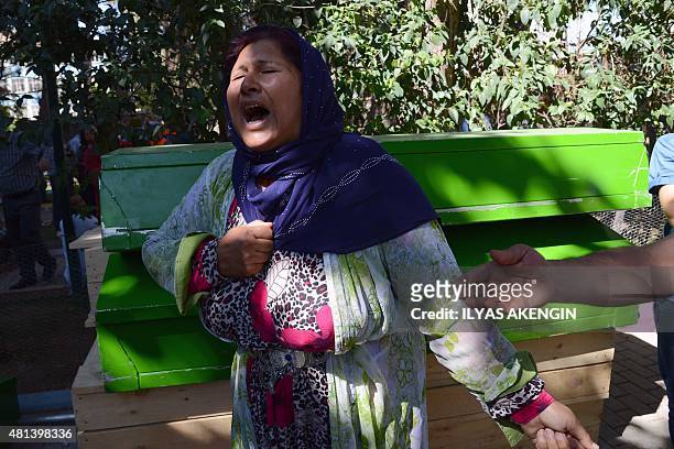 Woman cries next to the coffin of a victim on July 20, 2015 after an explosion in the town of Suruc, not far from the Syrian border. At least 30...