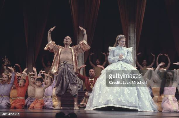 Yul Brenner performing on stage with the Broadway cast of 'The King and I' in 1977.