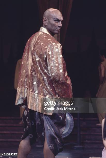 Yul Brenner performing on stage with the Broadway cast of 'The King and I' in 1977.