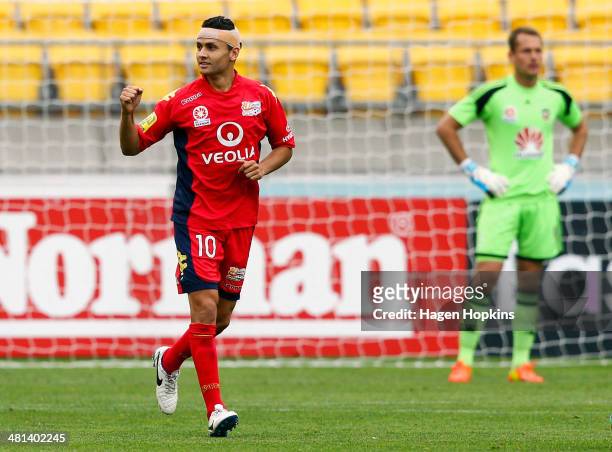 Marcelo Carrusca of Adelaide United celebrates after scoring a goal while Glen Moss of the Phoenix looks on during the round 25 A-League match...