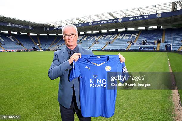 Manager Claudio Ranieri of Leicester City poses on the pitch with their football shirt during a Leicester City training session and press conference...