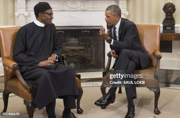 President Barack Obama speaks with Nigerian President Muhammadu Buhari during a meeting in the Oval Office of the White House in Washington, DC, July...