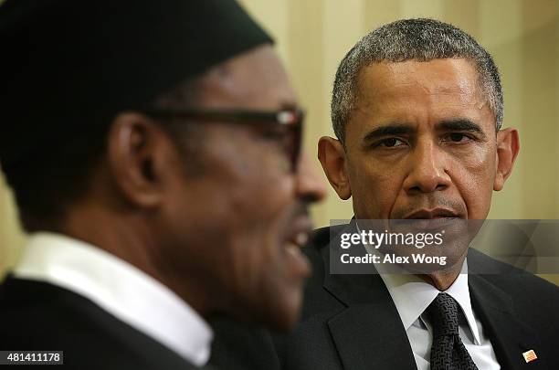 President Barack Obama listens as Nigerian President Muhammadu Buhari speaks during a meeting in the Oval Office of the White House July 20, 2015 in...