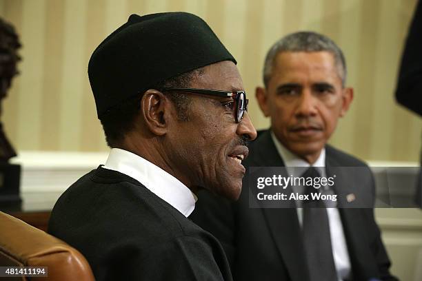 President Barack Obama listens as Nigerian President Muhammadu Buhari speaks during a meeting in the Oval Office of the White House July 20, 2015 in...