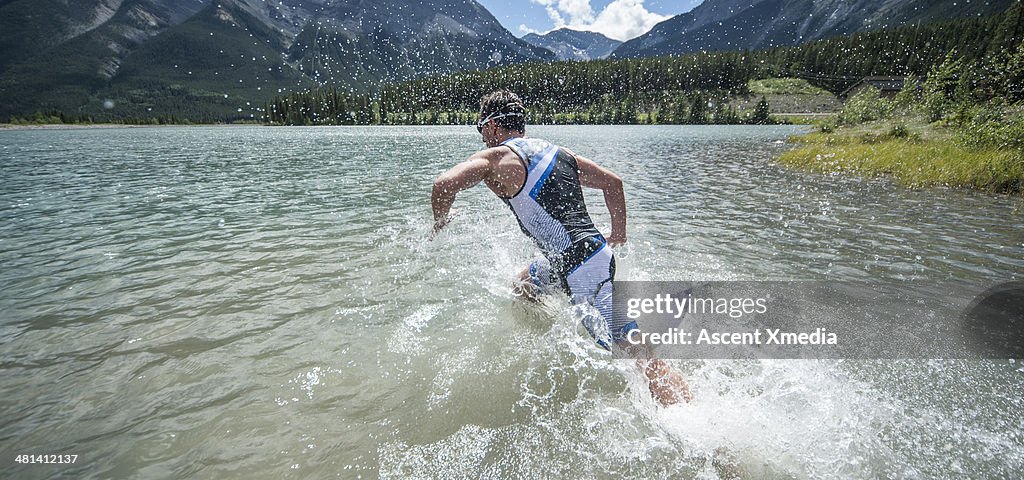 Swimmer plunging into mountain lake